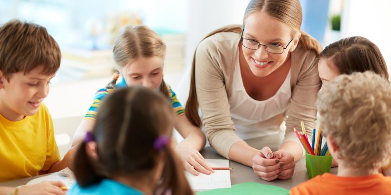 happy-teacher-listening-her-students